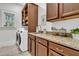 A bright laundry room with granite countertops and modern appliances at 2104 Royal Pine Dr, Seabrook Island, SC 29455