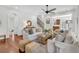 Bright living room with white couches, wooden floors and stairs to the second floor at 2104 Royal Pine Dr, Seabrook Island, SC 29455