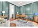 Stylish office with beautiful wall paneling, hardwood floors, and elegant furnishings at 2104 Royal Pine Dr, Seabrook Island, SC 29455
