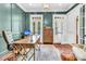 Sophisticated office featuring paneled walls, hardwood floors, and ample natural light at 2104 Royal Pine Dr, Seabrook Island, SC 29455