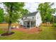Nice backyard with a fire pit, lawn, seating, and a screened-in outdoor entertaining area at 217 7Th Ave, Mount Pleasant, SC 29464