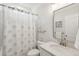Bathroom with a white vanity and shower with decorative blue and white shower curtain at 217 7Th Ave, Mount Pleasant, SC 29464