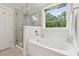 Bright bathroom with tub and separate shower featuring decorative tile at 217 7Th Ave, Mount Pleasant, SC 29464