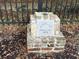 Historic Scanlonville cornerstone marker featuring a dated plaque and brick base along an iron fence at 217 7Th Ave, Mount Pleasant, SC 29464