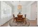 Bright dining room with wainscoting, round table, four chairs, and a stylish chandelier at 217 7Th Ave, Mount Pleasant, SC 29464