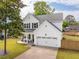 Beautiful two-story house with white siding, black shutters, a manicured lawn, and a two-car garage at 217 7Th Ave, Mount Pleasant, SC 29464