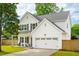 Charming two-story home featuring white siding, a well-manicured lawn, and an attached two-car garage at 217 7Th Ave, Mount Pleasant, SC 29464