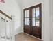 Elegant foyer with wood floors, a staircase with white railing, and a view of the front doors at 217 7Th Ave, Mount Pleasant, SC 29464