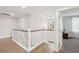Brightly lit hallway with wood flooring, leading to a room with a view and a decorative light fixture at 217 7Th Ave, Mount Pleasant, SC 29464
