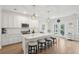 Bright white kitchen with an island and seating, stainless steel appliances and lots of light at 217 7Th Ave, Mount Pleasant, SC 29464