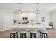 Bright kitchen with white cabinets, marble countertops, pendant lighting, subway tile backsplash, and stainless appliances at 217 7Th Ave, Mount Pleasant, SC 29464