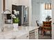 Close up of a kitchen island featuring a stainless faucet, white marble countertop, and stainless dishwasher at 217 7Th Ave, Mount Pleasant, SC 29464
