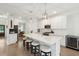 Bright kitchen with white cabinets, large island with seating, stainless steel appliances, and hardwood floors at 217 7Th Ave, Mount Pleasant, SC 29464