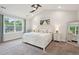 Large main bedroom featuring a ceiling fan, neutral carpet and a beach themed art piece at 217 7Th Ave, Mount Pleasant, SC 29464