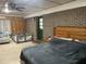 Bedroom features brick wall with a door and playpen adjacent to a large bed at 240 Kerrison St, Varnville, SC 29944