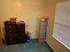 Modest bedroom with neutral walls, side cabinet, and good natural light from the window at 240 Kerrison St, Varnville, SC 29944