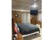 Cozy bedroom featuring wood paneling, modern curtains, and a mounted TV at 240 Kerrison St, Varnville, SC 29944
