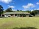 Charming single story brick home with a large front yard and boat parked on the side at 240 Kerrison St, Varnville, SC 29944