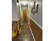 This hallway features wood flooring, light gray walls, and white trim at 240 Kerrison St, Varnville, SC 29944