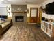 Cozy living room with a brick fireplace, wood-look flooring, and comfortable seating at 240 Kerrison St, Varnville, SC 29944