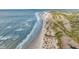 Coastal aerial view of a sandy beach meeting a lush, green shoreline on a sunny day at 2530 Jasper Blvd, Sullivans Island, SC 29482