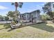 Charming backyard featuring a spacious wooden deck, lush lawn, and mature landscaping, perfect for outdoor entertaining at 2530 Jasper Blvd, Sullivans Island, SC 29482