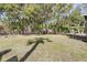 Large, grassy backyard featuring mature trees and partial shade, providing a serene outdoor space at 2530 Jasper Blvd, Sullivans Island, SC 29482