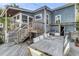 This backyard features a wooden deck with dining area and an outdoor kitchen with grill at 2530 Jasper Blvd, Sullivans Island, SC 29482