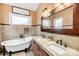 Elegant bathroom showcasing a clawfoot tub, double vanity, decorative mirror, and tiled walls at 2530 Jasper Blvd, Sullivans Island, SC 29482