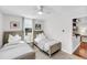 Bedroom featuring two twin beds, neutral decor, and a glimpse into an adjoining room at 2530 Jasper Blvd, Sullivans Island, SC 29482