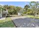 Wide driveway and grass lawn, complemented by palm trees and a charming storage shed in the back at 2530 Jasper Blvd, Sullivans Island, SC 29482