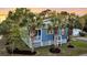 Charming beach house with palm trees, lush landscaping, and a welcoming front porch, epitomizing coastal living at 2530 Jasper Blvd, Sullivans Island, SC 29482