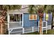 Charming home with a covered porch and palm trees, showcasing coastal curb appeal and relaxed outdoor living at 2530 Jasper Blvd, Sullivans Island, SC 29482