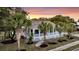Charming home with a welcoming wrap-around porch and beautiful tropical landscaping at 2530 Jasper Blvd, Sullivans Island, SC 29482