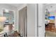 Hallway view with closet and doorway leading to a bedroom with a canopy bed and flatscreen TV at 2530 Jasper Blvd, Sullivans Island, SC 29482