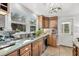 Kitchen featuring stainless steel sink under a window plus wooden cabinets and tiled backsplash at 2530 Jasper Blvd, Sullivans Island, SC 29482