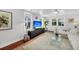 Airy living room with modern decor, hardwood floors, and natural light from multiple windows at 2530 Jasper Blvd, Sullivans Island, SC 29482