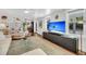 Bright, spacious living room with hardwood floors, a custom entertainment unit, and modern decor at 2530 Jasper Blvd, Sullivans Island, SC 29482