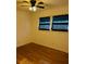 Bedroom with hardwood flooring, ceiling fan, and two windows with dark blinds at 26 Elmora Ave, Goose Creek, SC 29445