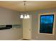 Cozy dining area with neutral paint, updated lighting, and a large window at 26 Elmora Ave, Goose Creek, SC 29445