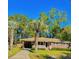 Charming single-story brick home featuring a well-maintained lawn and mature palm trees at 26 Elmora Ave, Goose Creek, SC 29445