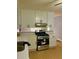 Well-lit kitchen boasts white cabinetry, stainless steel appliances, and light countertops at 26 Elmora Ave, Goose Creek, SC 29445