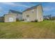 Backyard featuring well-maintained lawn, storage shed, and home exterior at 3033 Kinswood Ln, Ladson, SC 29456