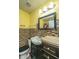 Bright yellow bathroom featuring mosaic tile accent wall and framed mirror at 3033 Kinswood Ln, Ladson, SC 29456