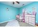Bright bedroom with crib, dresser, ceiling fan, and turquoise walls at 3033 Kinswood Ln, Ladson, SC 29456
