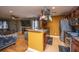 Open concept kitchen with stainless steel appliances, wooden cabinets, and a hanging pot rack at 3033 Kinswood Ln, Ladson, SC 29456