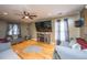 Inviting living room with hardwood floors, large TV, ceiling fan, and comfortable seating at 3033 Kinswood Ln, Ladson, SC 29456