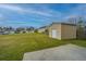 Backyard shed with siding and a concrete pad at 3033 Kinswood Ln, Ladson, SC 29456