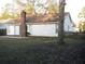 Quaint backyard view of a single Gathering home, showcasing a brick chimney, patio, and fenced yard at 315 Indigo Rd, Goose Creek, SC 29445