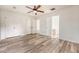 Spacious bedroom featuring wood-look floors, ceiling fan, and ensuite bathroom with double closets at 315 Indigo Rd, Goose Creek, SC 29445